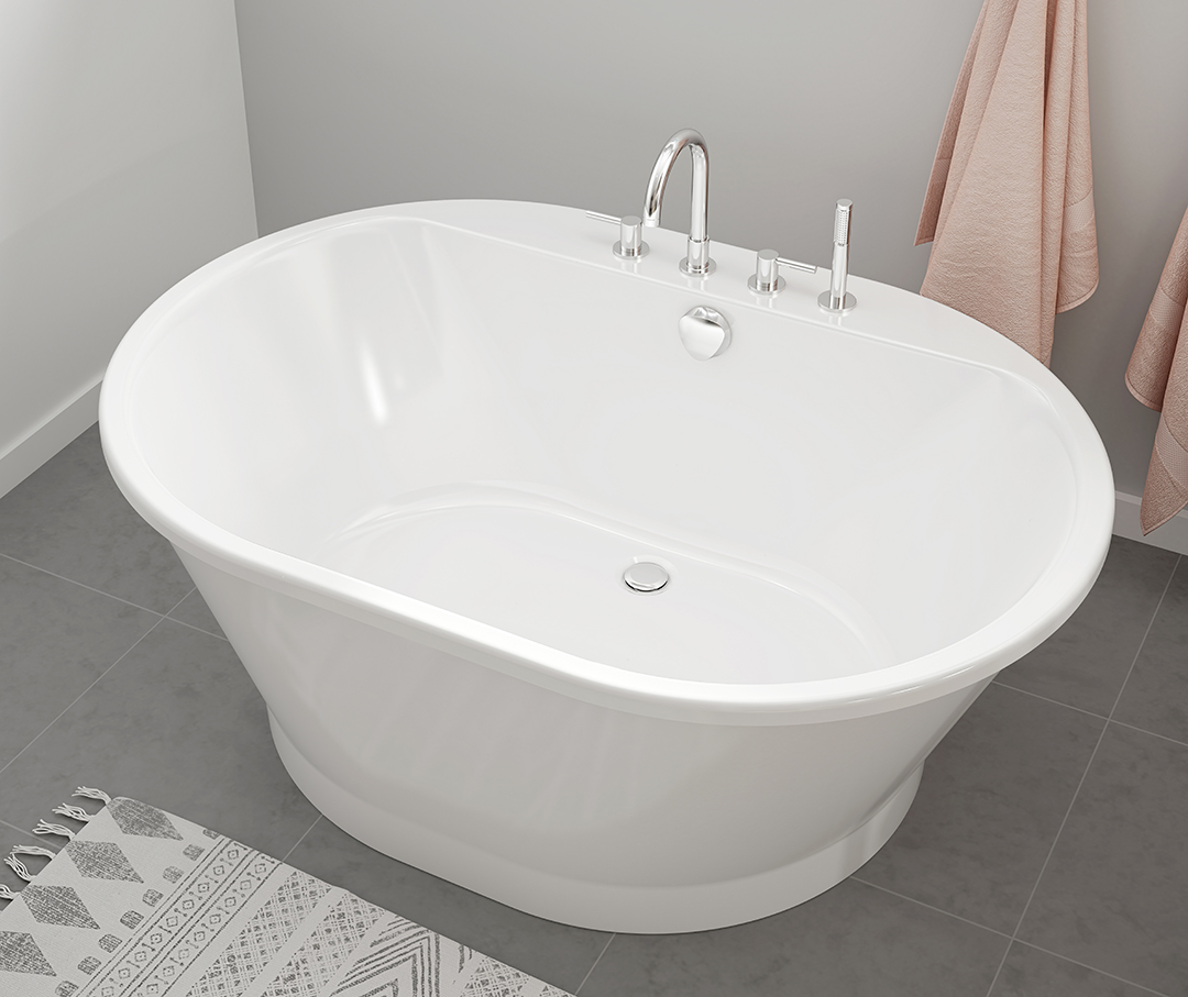 Oval tub with chrome faucet in a tiled bathroom.