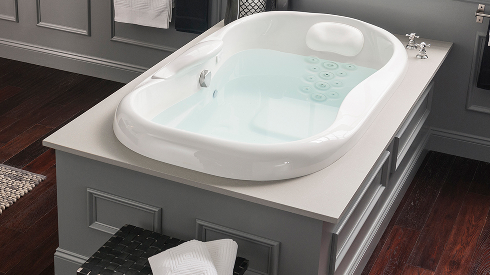 Image of a tub with a whirlpool jet system skirted in the middle of the floor.