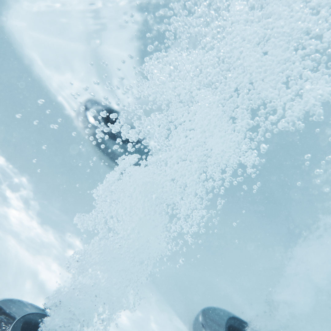 Image of jets in a whirlpool system blowing under water.