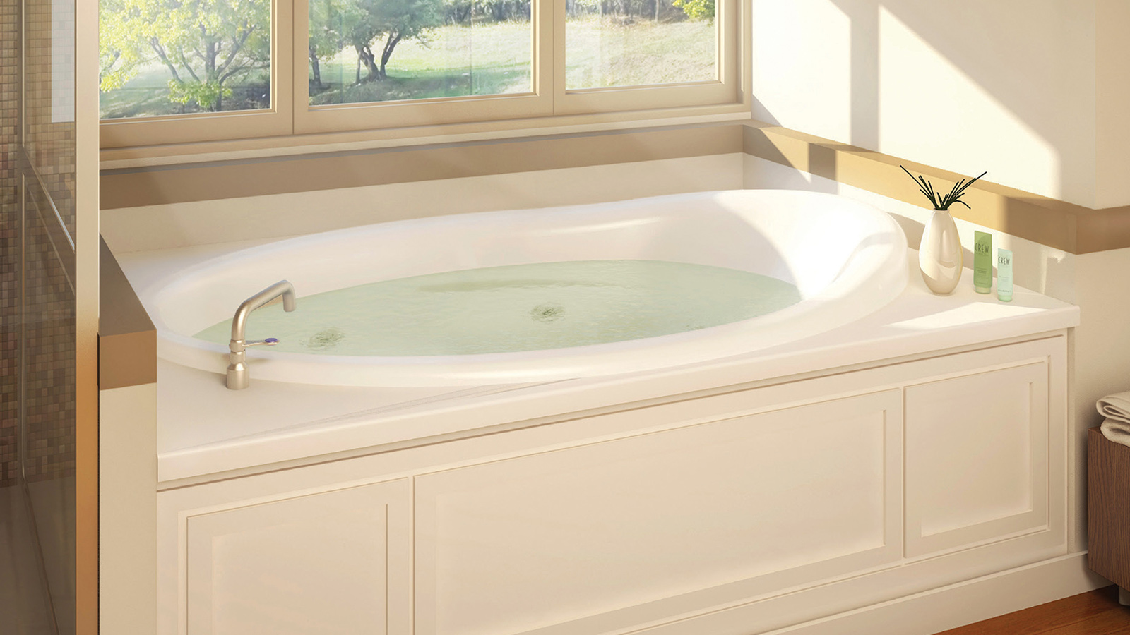 Image of an oval deep soaking tub with jets under windows looking to the back yard.